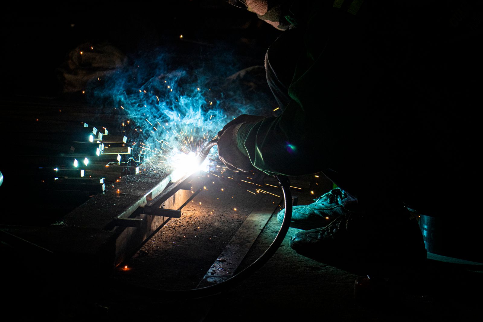 A welding arc throwing sparks during fabrication